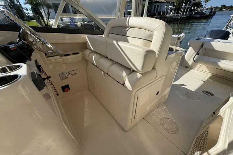 Slide: The Image of 2016 Grady-White Freedom 307 boat interior with helm and seating area. - 8
