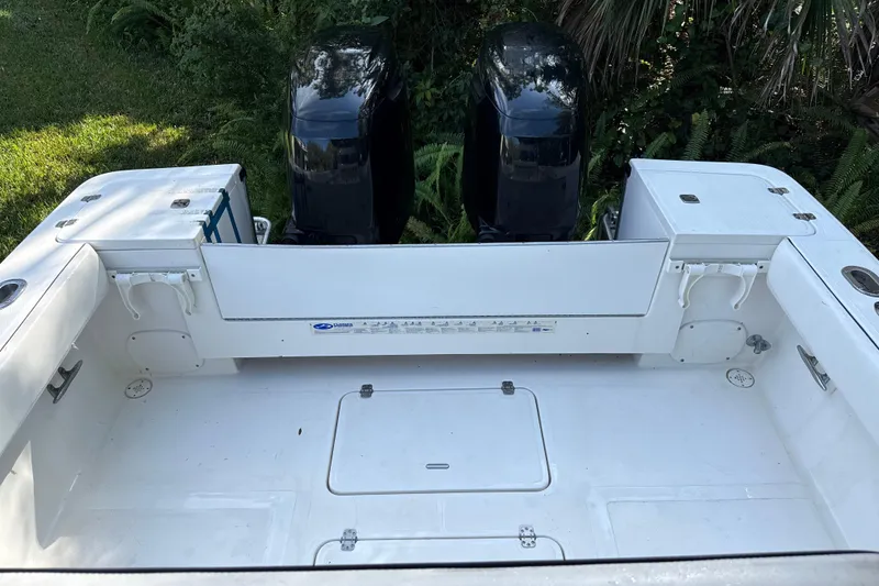 Slide: The Image of 2002 SeaCraft SC32 Master Angler boat with dual outboard motors, spacious deck, and storage compartments. - 10