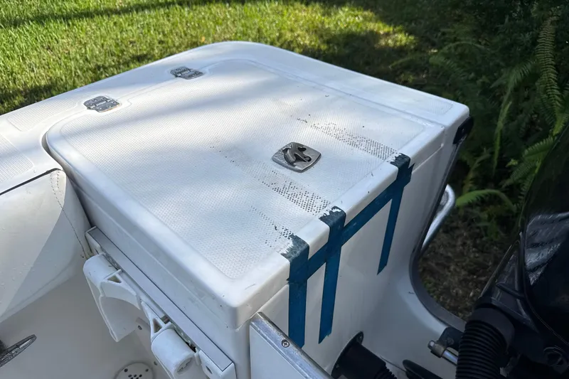 Slide: The Image of 2002 SeaCraft SC32 Master Angler boat compartment with blue tape and latch detail. - 12