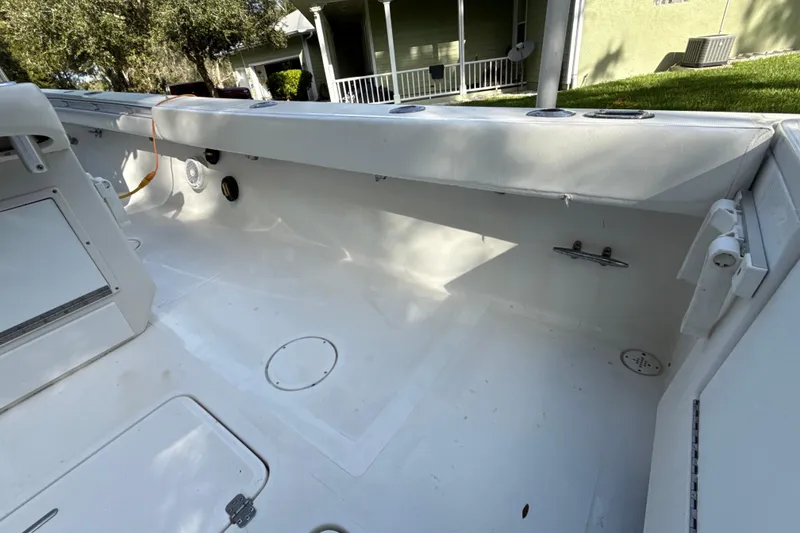 Slide: The Image of 2002 SeaCraft SC32 Master Angler boat interior, featuring spacious white deck and storage compartments. - 14