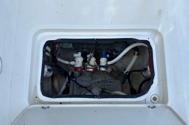 Slide: The Image of 2002 SeaCraft SC32 Master Angler boat compartment with visible wiring and plumbing components. - 15