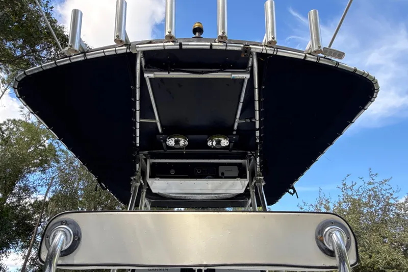 Slide: The Image of 2002 SeaCraft SC32 Master Angler boat with T-top and rod holders against blue sky. - 17