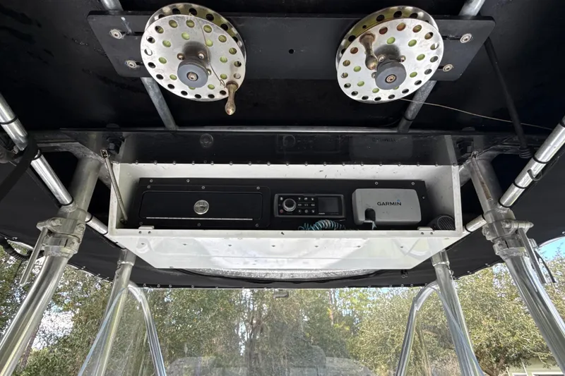 Slide: The Image of 2002 SeaCraft SC32 Master Angler boat electronics and equipment under canopy. - 18