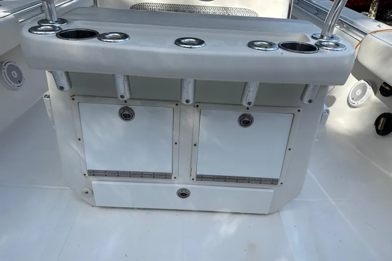 Slide: The Image of 2002 SeaCraft SC32 Master Angler boat console with rod holders and storage compartments. - 19