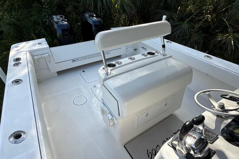 Slide: The Image of 2002 SeaCraft SC32 Master Angler boat cockpit with dual engines and white seating. - 21