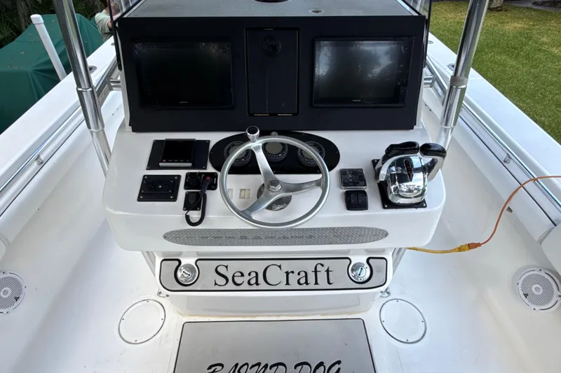 Slide: The Image of 2002 SeaCraft SC32 Master Angler boat console with steering wheel and navigation equipment. - 24