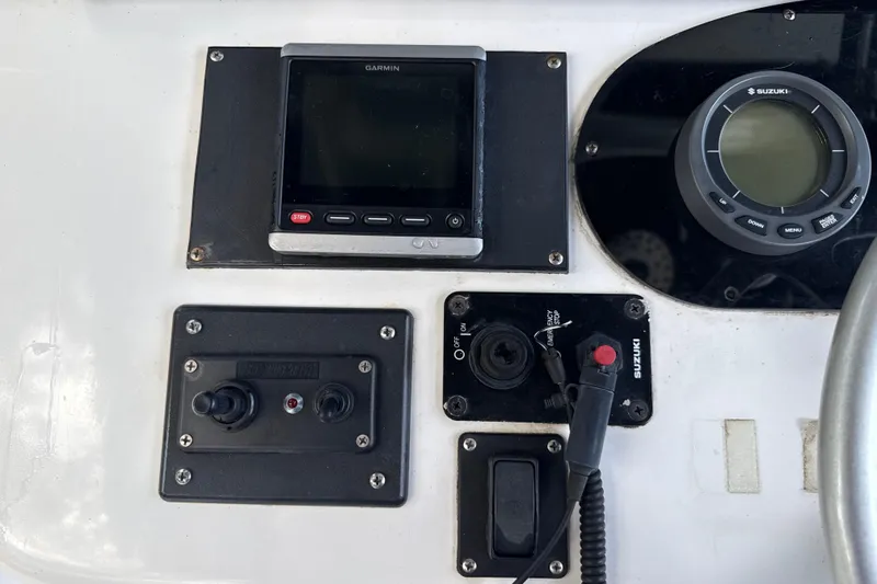 Slide: The Image of Control panel of 2002 SeaCraft SC32 Master Angler with Garmin and Suzuki displays. - 28