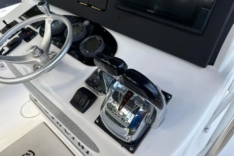 Slide: The Image of Console of 2002 SeaCraft SC32 Master Angler with steering wheel and controls. - 29