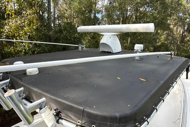 Slide: The Image of 2002 SeaCraft SC32 Master Angler boat with radar equipment, surrounded by trees. - 32