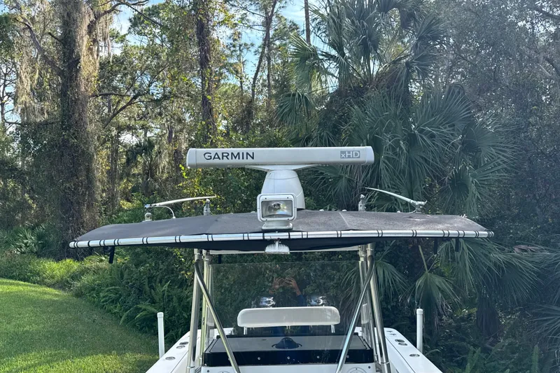 Slide: The Image of 2002 SeaCraft SC32 Master Angler with Garmin radar, surrounded by lush greenery. - 33