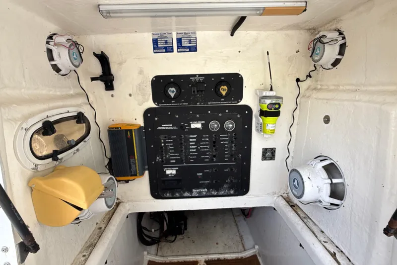 Slide: The Image of 2002 SeaCraft SC32 Master Angler control panel with speakers and equipment in cabin. - 36