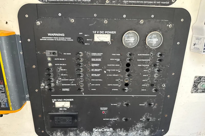 Slide: The Image of Control panel of a 2002 SeaCraft SC32 Master Angler boat, featuring various switches and gauges. - 39