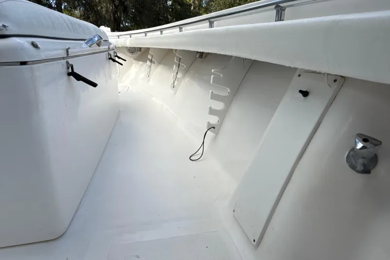 Slide: The Image of 2002 SeaCraft SC32 Master Angler boat interior with white deck and storage compartments. - 43