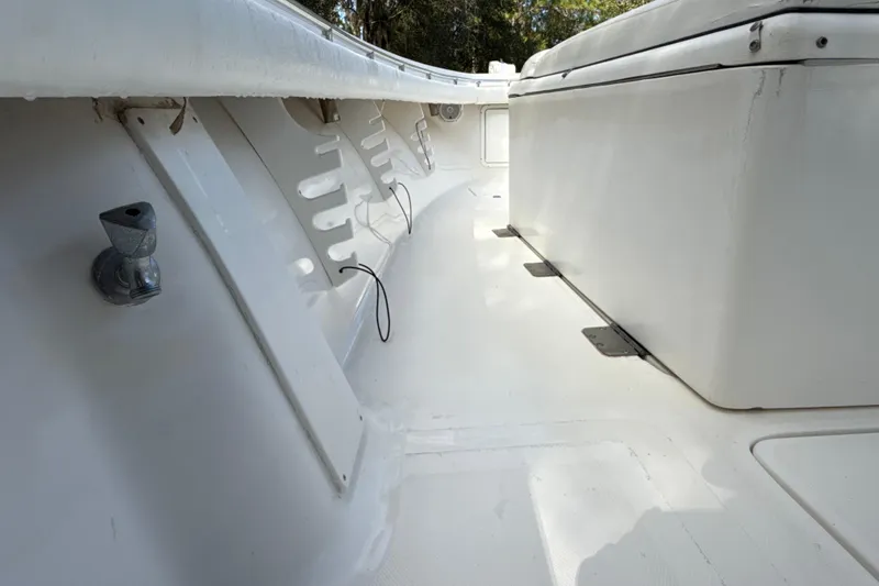 Slide: The Image of 2002 SeaCraft SC32 Master Angler boat interior with storage compartment and clean white deck. - 45