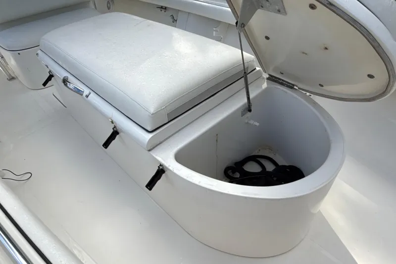 Slide: The Image of 2002 SeaCraft SC32 Master Angler boat storage compartment with cushioned seat and open lid. - 46