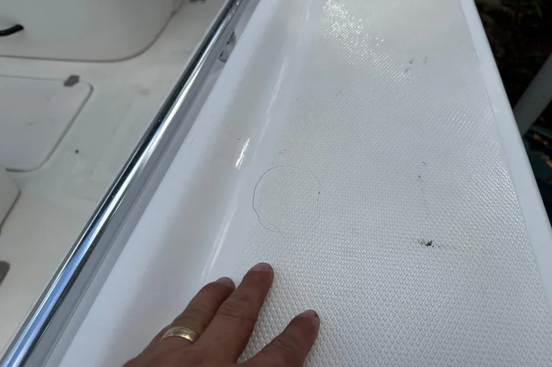 Slide: The Image of Hand touching textured surface of 2002 SeaCraft SC32 Master Angler boat. - 53