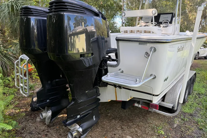 Slide: The Image of 2002 SeaCraft SC32 Master Angler boat with dual outboard motors on a trailer. - 7