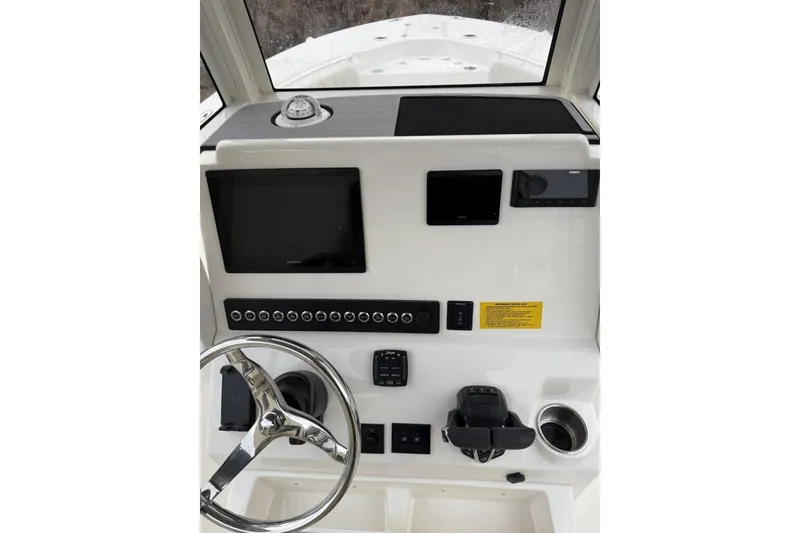 Slide: The Image of 2026 Key West 244 Center Console boat interior with seating and storage compartments. - 10