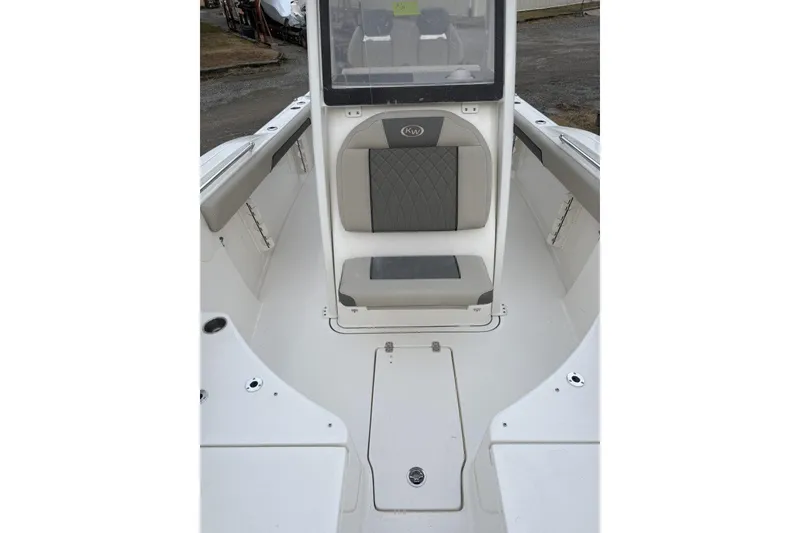 Slide: The Image of 2026 Key West 244 Center Console boat dashboard with steering wheel and electronic controls. - 11