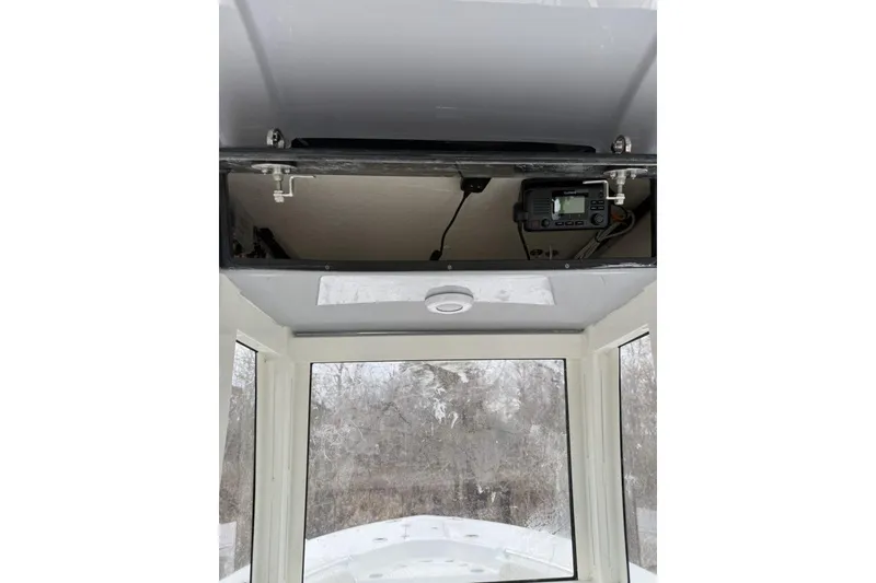 Slide: The Image of 2026 Key West 244 Center Console boat deck with storage compartments and cup holders. - 13