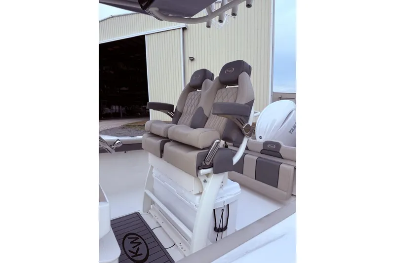 Slide: The Image of 2026 Key West 244 Center Console boat interior with steering wheel and seating. - 4