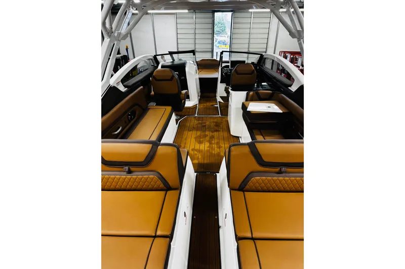 Slide: The Image of 2024 Yamaha Boats 275SD interior with luxurious tan seating and sleek design. - 13