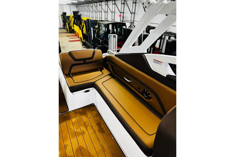 Slide: The Image of 2024 Yamaha Boats 275SD interior with brown seating and wood flooring. - 15