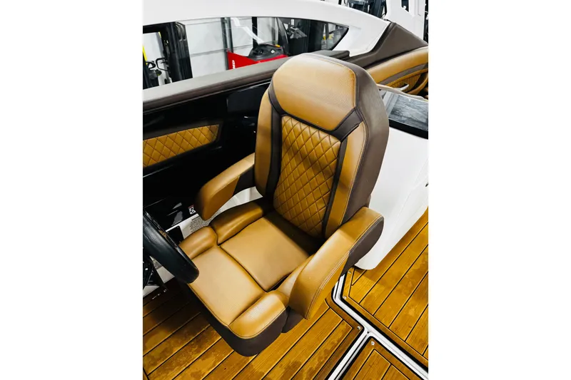 Slide: The Image of Luxurious tan and brown captain's seat on 2024 Yamaha Boats 275SD. - 17