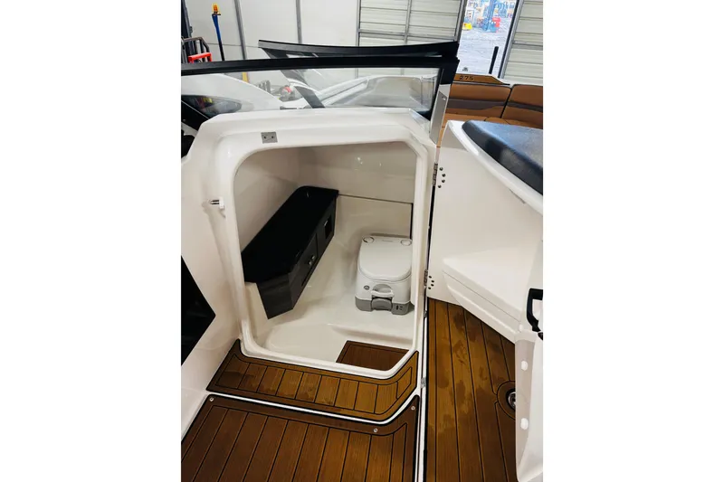 Slide: The Image of 2024 Yamaha Boats 275SD interior with compact marine toilet and storage. - 19