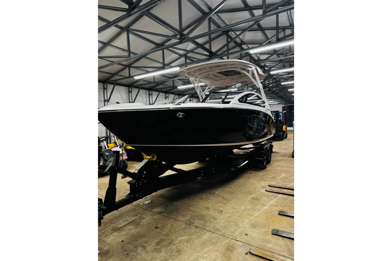 Slide: The Image of 2024 Yamaha Boats 275SD in a warehouse, showcasing sleek design and modern features. - 2