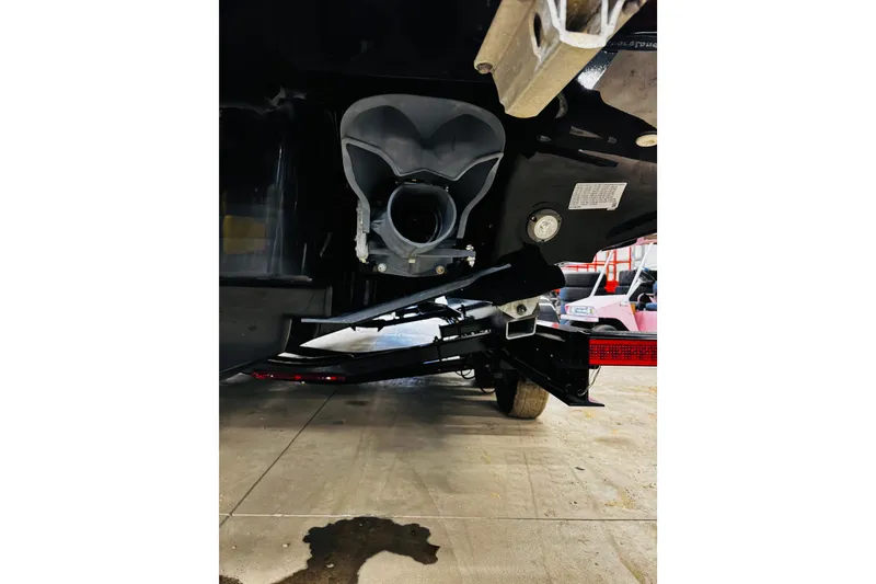 Slide: The Image of 2024 Yamaha Boats 275SD underside view, showcasing the propulsion system and trailer. - 29