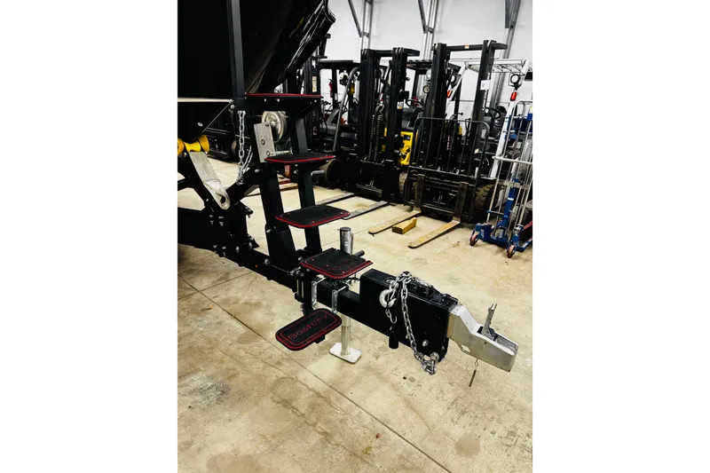 Slide: The Image of Trailer hitch with steps for 2024 Yamaha Boats 275SD in a warehouse setting. - 32