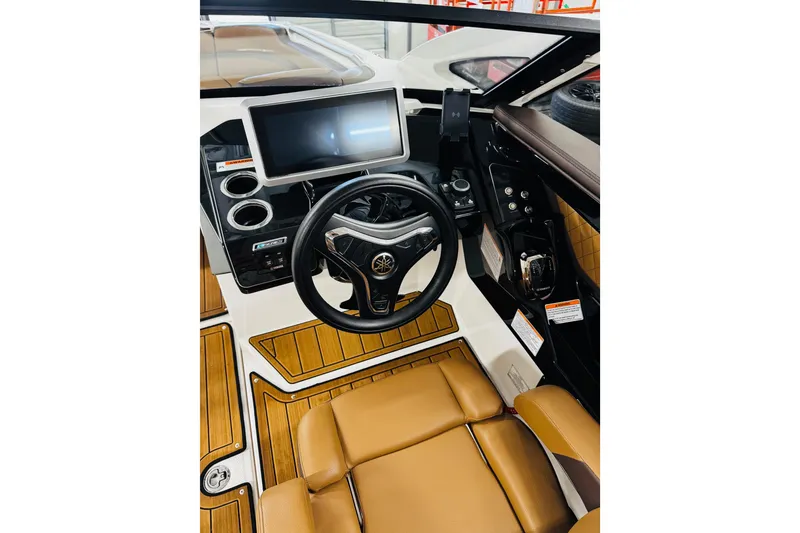 Slide: The Image of 2024 Yamaha Boats 275SD helm with modern controls and luxurious seating. - 7
