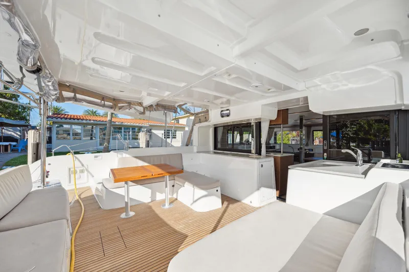 Slide: The Image of 2022 Lagoon 46 catamaran interior with spacious seating and modern design. - 19