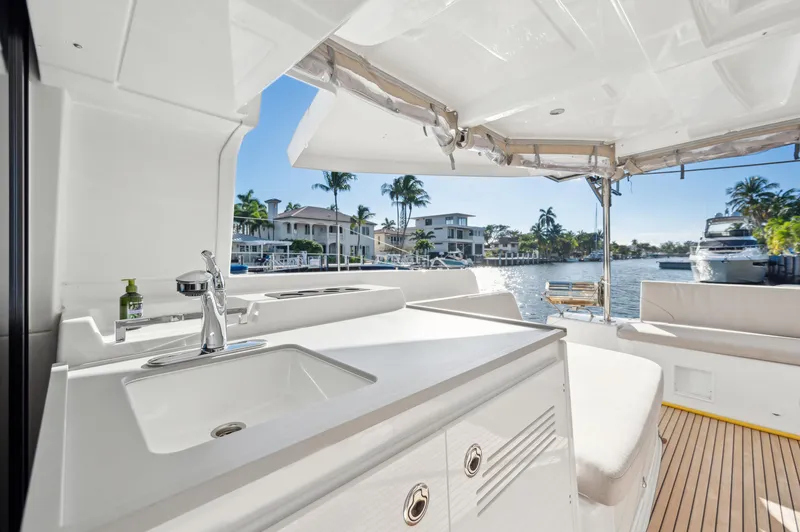 Slide: The Image of 2022 Lagoon 46 yacht interior with sink, seating, and waterfront view. - 21