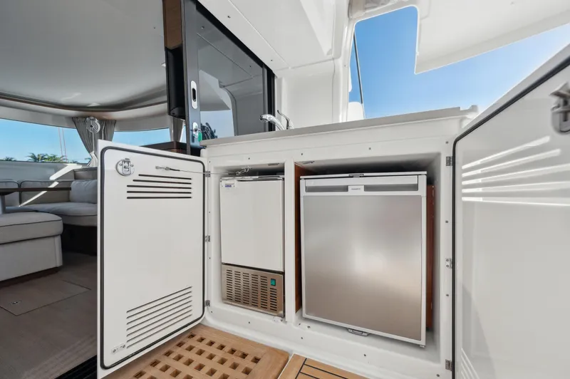 Slide: The Image of 2022 Lagoon 46 yacht interior with open storage compartments and appliances. - 24