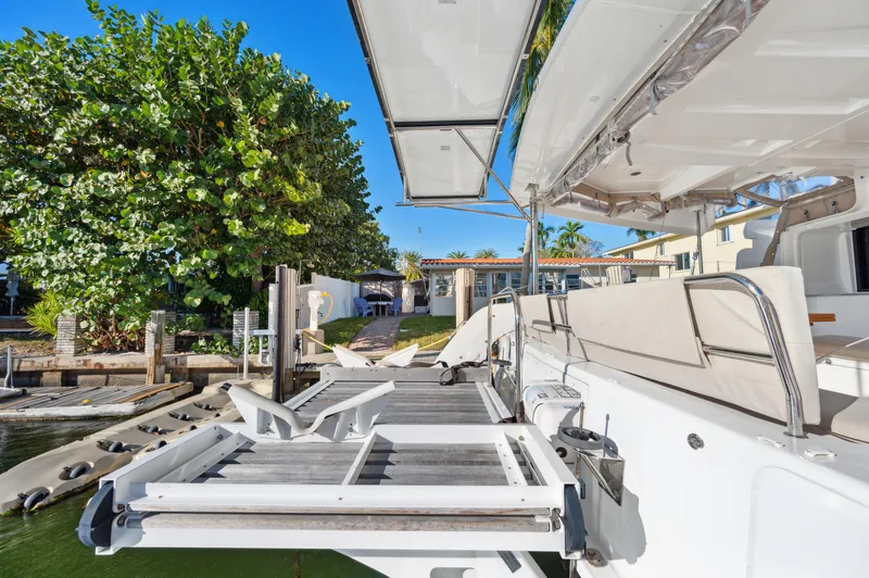 Slide: The Image of 2022 Lagoon 46 catamaran docked, featuring spacious deck and modern design. - 27