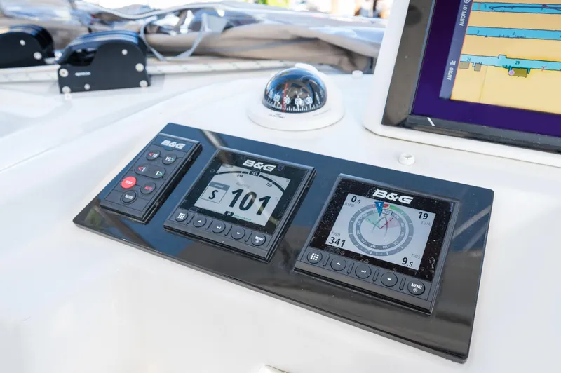 Slide: The Image of Control panel of 2022 Lagoon 46 catamaran with navigation instruments and compass. - 38