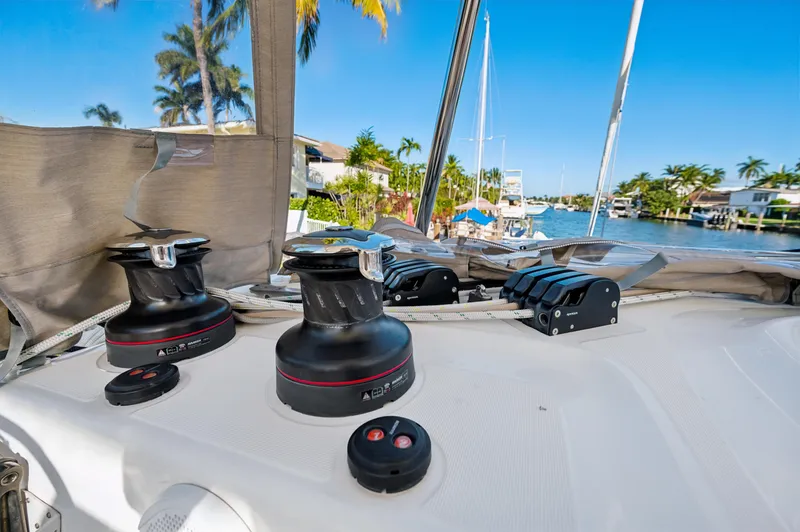 Slide: The Image of 2022 Lagoon 46 yacht deck with winches and tropical waterfront view. - 40