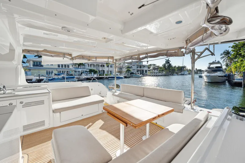 Slide: The Image of 2022 Lagoon 46 yacht interior with seating area, table, and waterfront view. - 41