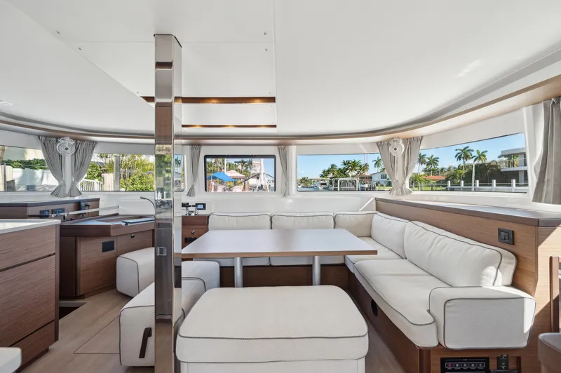 Slide: The Image of Luxurious interior of 2022 Lagoon 46 yacht with spacious seating and panoramic windows. - 46