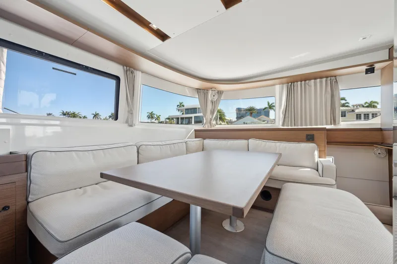 Slide: The Image of Interior of 2022 Lagoon 46 catamaran with spacious seating and large windows. - 49