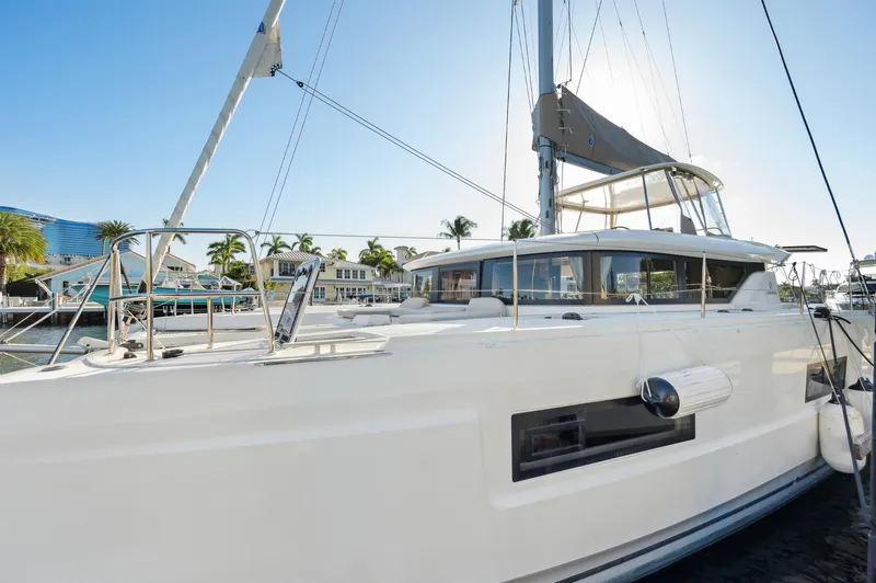 Slide: The Image of 2022 Lagoon 46 catamaran docked in a sunny marina setting. - 9