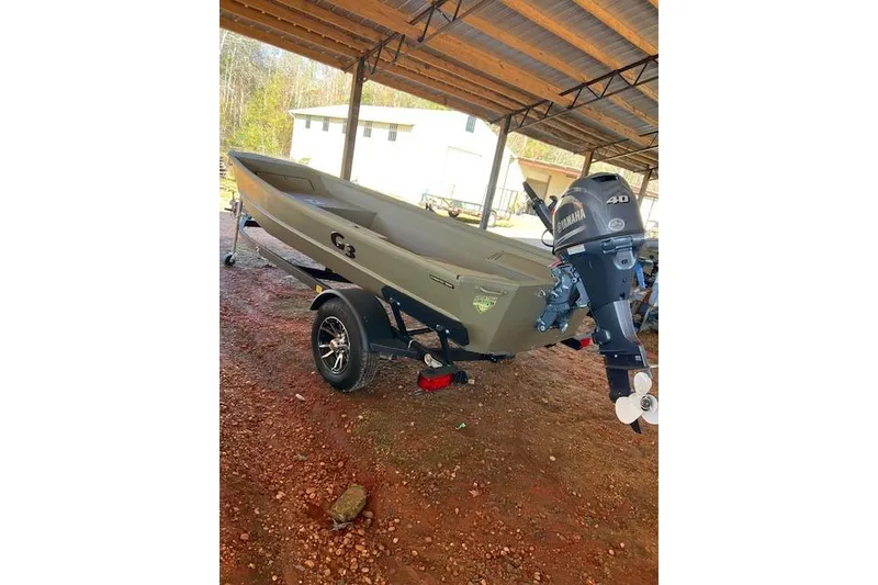 Slide: The Image of 2025 G3 Gator Tough 15 DK boat with Yamaha motor on trailer, parked under shelter. - 5