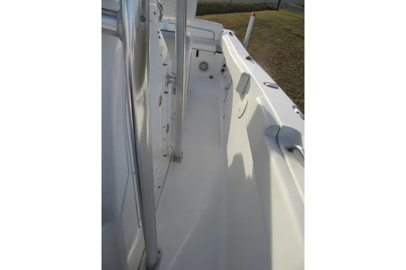 Slide: The Image of 2014 Sea Hunt Ultra 234 boat interior, featuring sleek white deck and stainless steel fittings. - 14