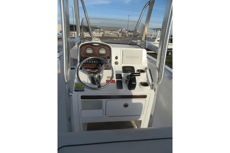 Slide: The Image of 2014 Sea Hunt Ultra 234 boat console with steering wheel and Garmin navigation system. - 18