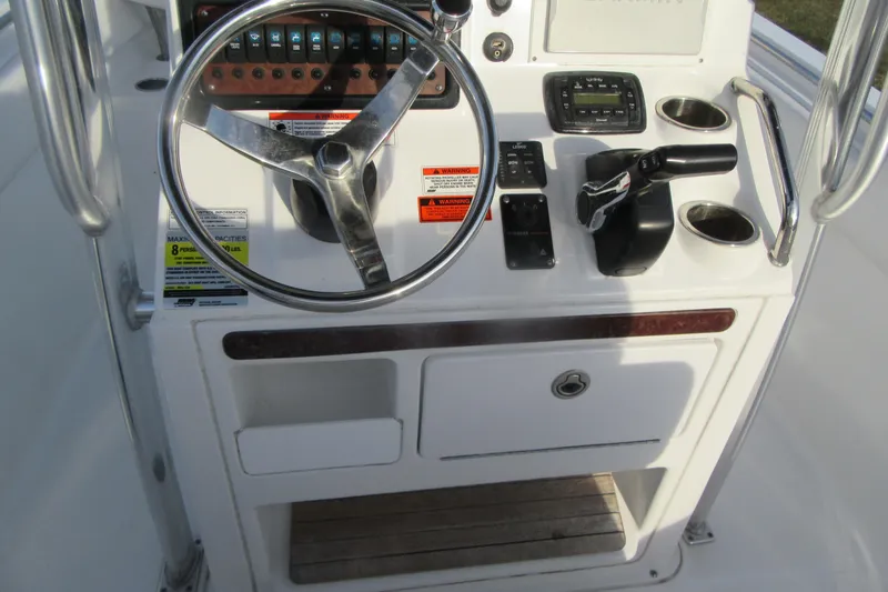 Slide: The Image of Control panel of a 2014 Sea Hunt Ultra 234 boat with steering wheel and controls. - 19
