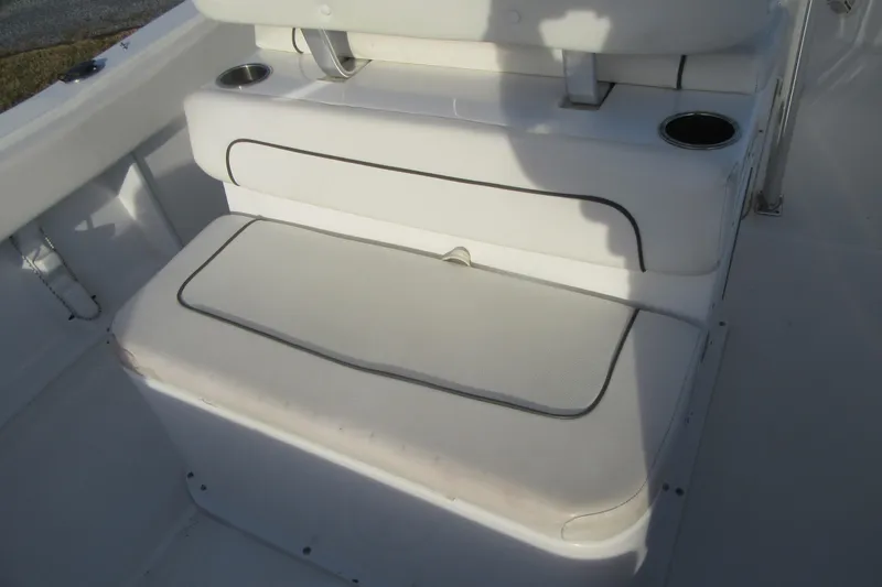 Slide: The Image of 2014 Sea Hunt Ultra 234 boat seating area with cup holders and cushioned seats. - 29
