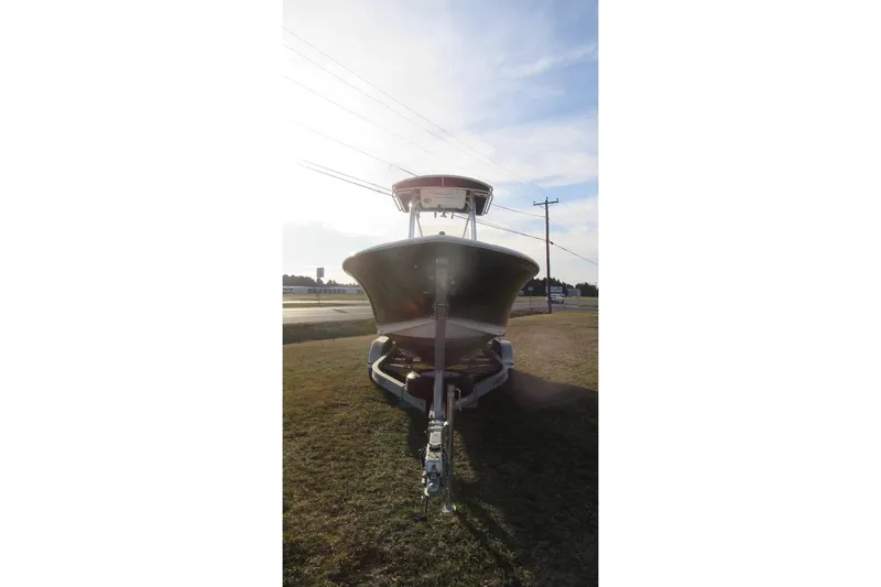 Slide: The Image of 2014 Sea Hunt Ultra 234 boat on trailer, parked on grass under a clear sky. - 3