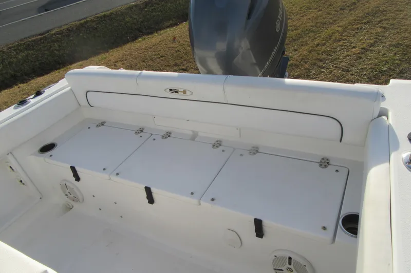 Slide: The Image of 2014 Sea Hunt Ultra 234 boat interior with storage compartments and seating. - 31